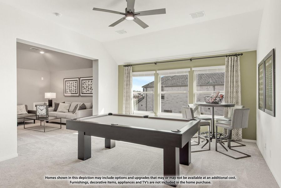 Game room with pool table, ceiling fan, and bar-height seating area on carpet flooring Game room with pool table, ceiling fan, and bar-height seating area on carpet flooring