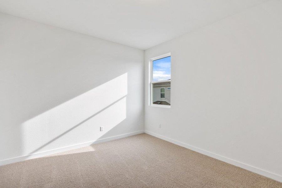 Empty room with baseboards and carpet flooring