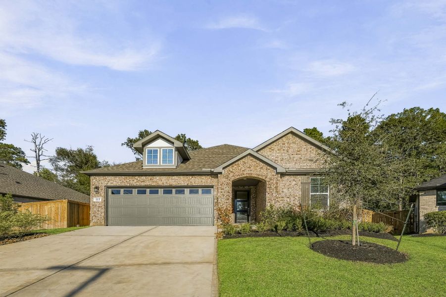 Front exterior of a new home in The Woodlands Hills, Willis, TX, highlighting curb appeal (Image 1). Front exterior of a new home in The Woodlands Hills, Willis, TX, highlighting curb appeal (Image 1).