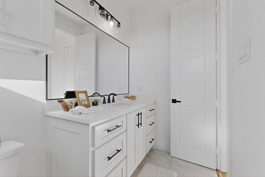 Half bathroom featuring vanity and toilet Half bathroom featuring vanity and toilet