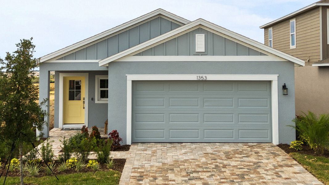 This view of The Atlantic at Hamilton Bluff highlights the charming covered porch, 2-car garage, and paved driveway.