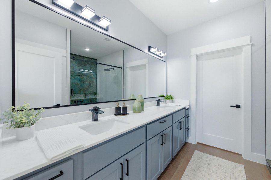 Full bath featuring a shower stall, double vanity, dark wood-style flooring, and recessed lighting Full bath featuring a shower stall, double vanity, dark wood-style flooring, and recessed lighting