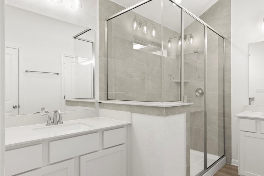 Bathroom with a stall shower and two vanities