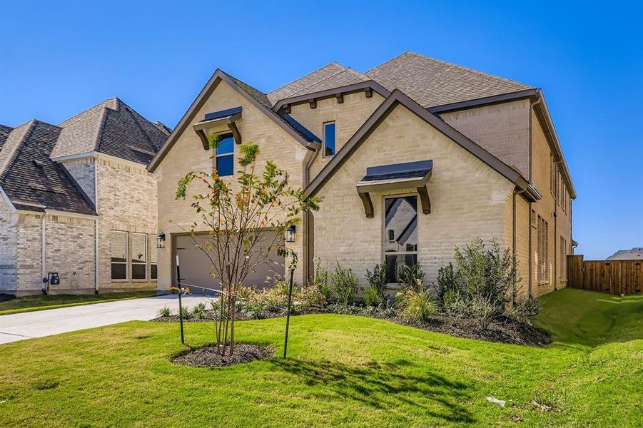 View of front of home featuring brick siding, concrete driveway, a shingled roof, and an attached garage