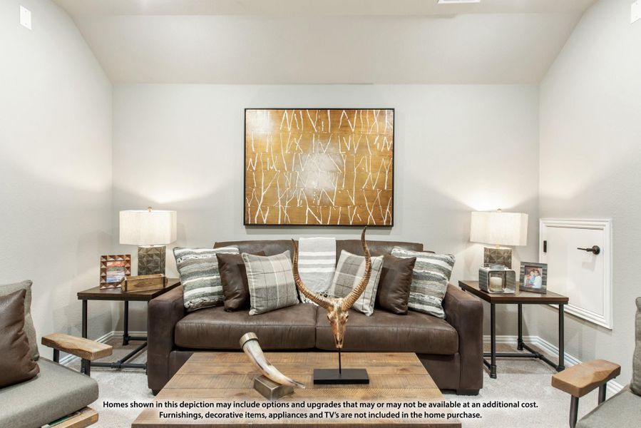 Living room with brown leather sofa, decorative pillows, wood coffee table, and large wall art above the couch.