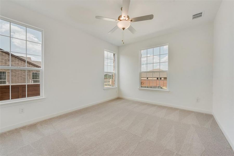 Spare room with light carpet and ceiling fan