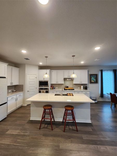 Culinary aspirations come alive in this kitchen, featuring an inviting island with seating.
