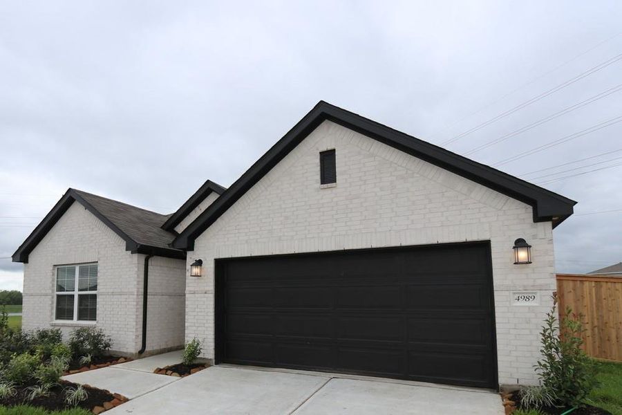 Front exterior of a new home in Ambrose, La Marque, TX, highlighting curb appeal (Image 2). Front exterior of a new home in Ambrose, La Marque, TX, highlighting curb appeal (Image 2).