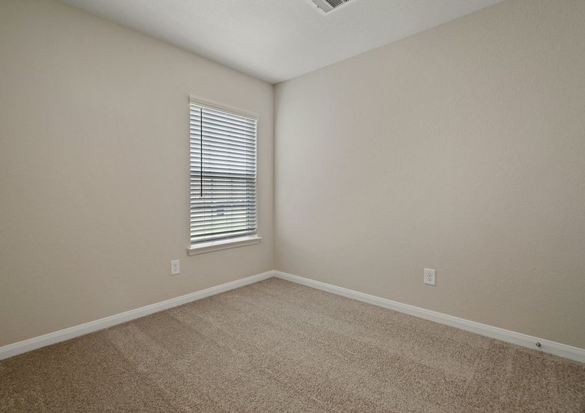 Secondary bedroom with lush carpet flooring