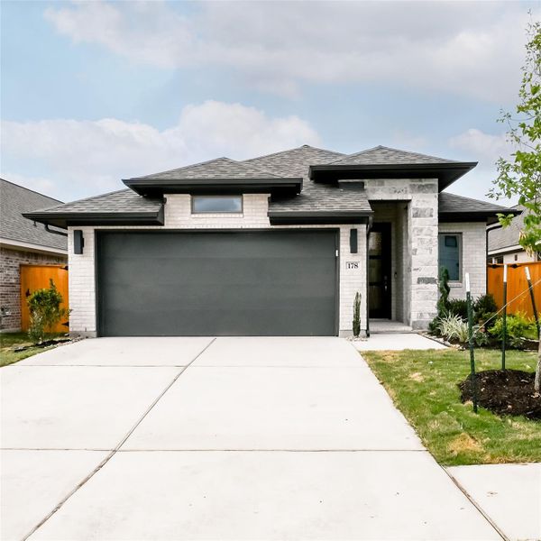 Front exterior of a new home in Crosswinds, Kyle, TX, highlighting curb appeal (Image 21).