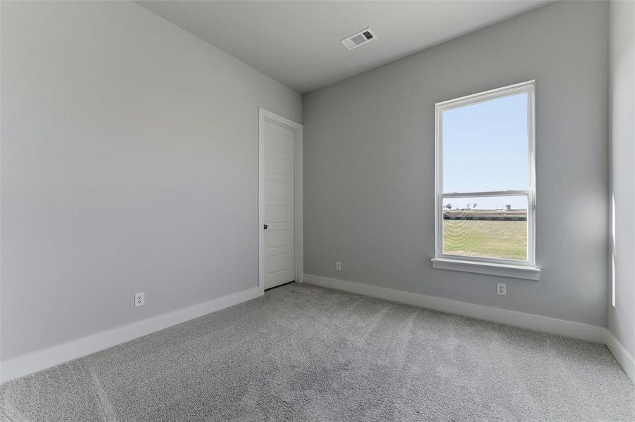 Empty room with carpet flooring and baseboards