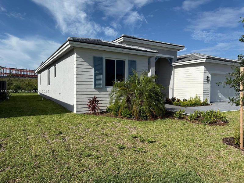 Front exterior of a new home in , Homestead, FL, highlighting curb appeal (Image 20). Front exterior of a new home in , Homestead, FL, highlighting curb appeal (Image 20).