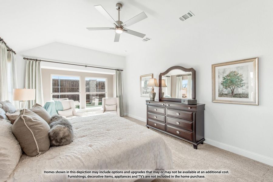 Spacious master bedroom with vaulted ceiling, ceiling fan, carpet floors, and dark wood dresser with mirror Spacious master bedroom with vaulted ceiling, ceiling fan, carpet floors, and dark wood dresser with mirror