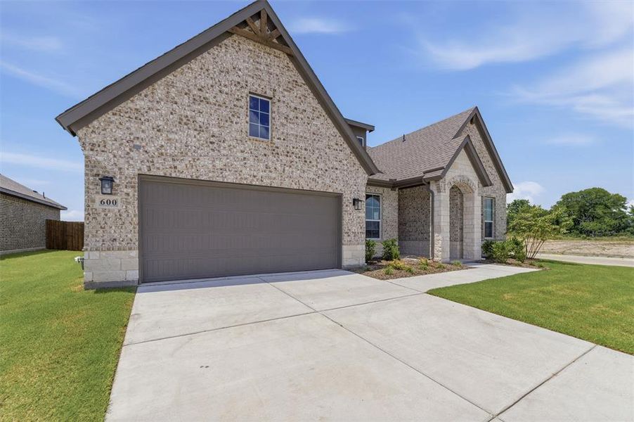 Stone and brick exterior with a two-car garage Stone and brick exterior with a two-car garage
