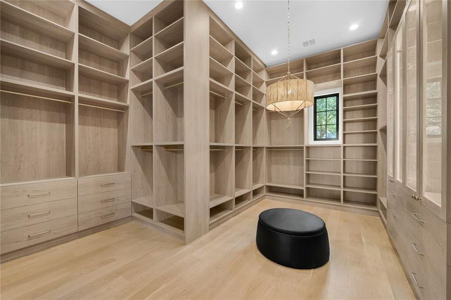 Custom built-in closet system featuring extensive shelving, hanging rods, and integrated drawers