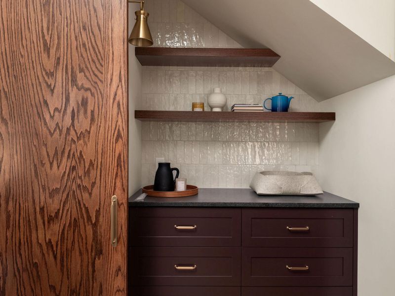 Smart storage and rich wood details elevate this versatile interior space.
