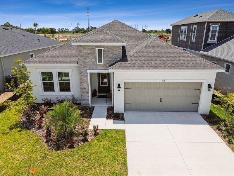 Front exterior of a new home in Waterset, Apollo Beach, FL, highlighting curb appeal (Image 24). Front exterior of a new home in Waterset, Apollo Beach, FL, highlighting curb appeal (Image 24).