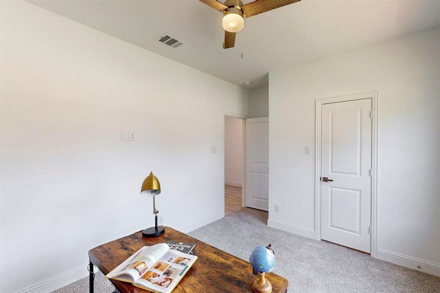 Carpeted home office with ceiling fan