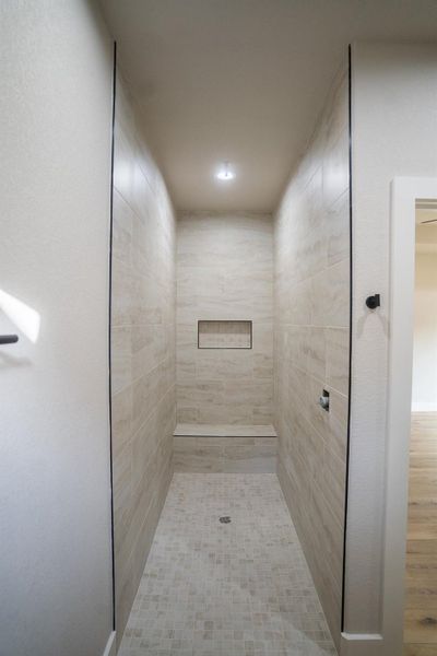 Full bath featuring a tile shower.