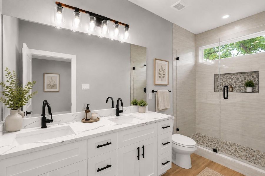 primary bathroom with shower and double sinks and luxury finishes