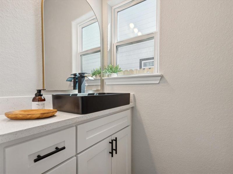 Bathroom with a healthy amount of sunlight and vanity