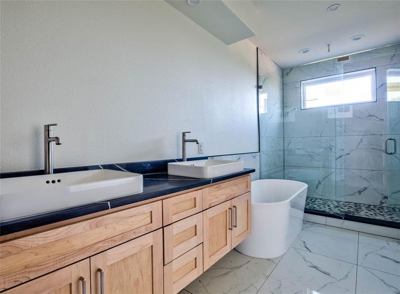 Bathroom with vanity and separate shower and tub