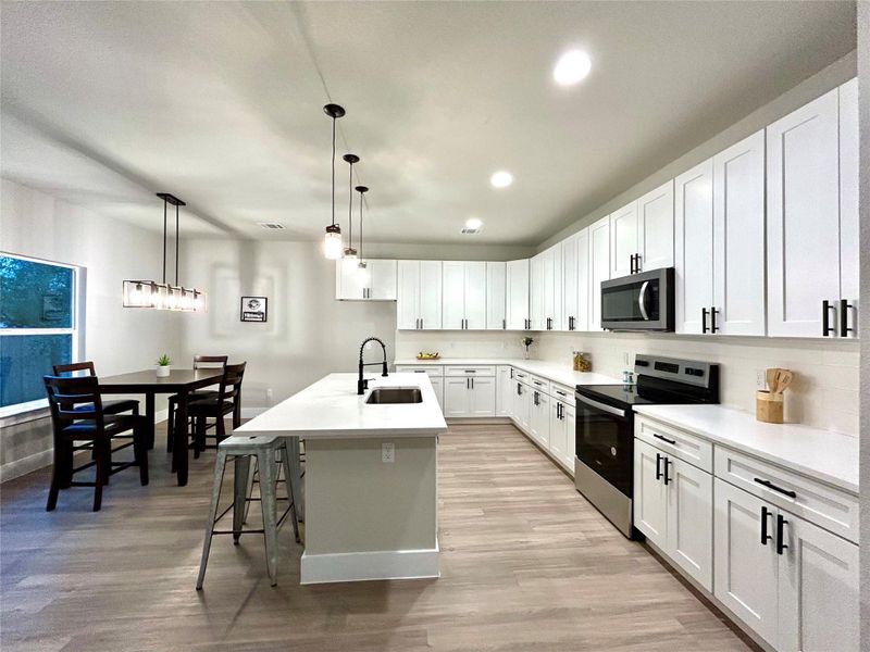 Spacious kitchen with island and plenty of cabinets.