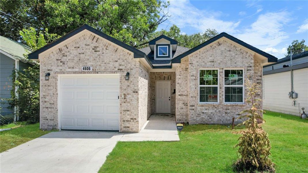 View of front of property with a front lawn and a garage