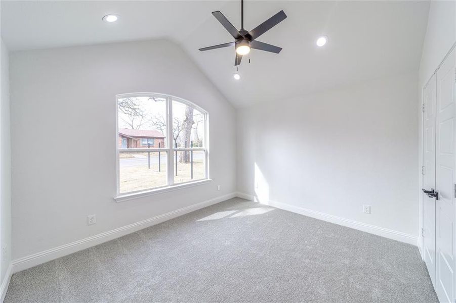 Unfurnished room with lofted ceiling, carpet, and baseboards