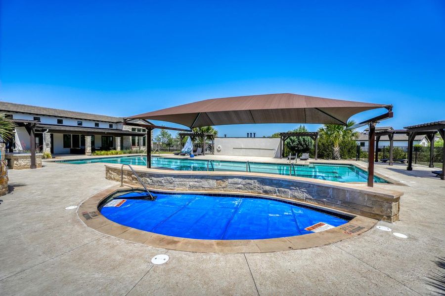 Community pool with a patio and a jacuzzi