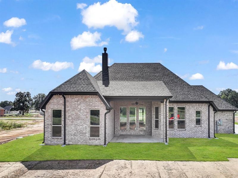 Rear view of house featuring a patio area, brick siding, a yard, and ceiling fan Rear view of house featuring a patio area, brick siding, a yard, and ceiling fan