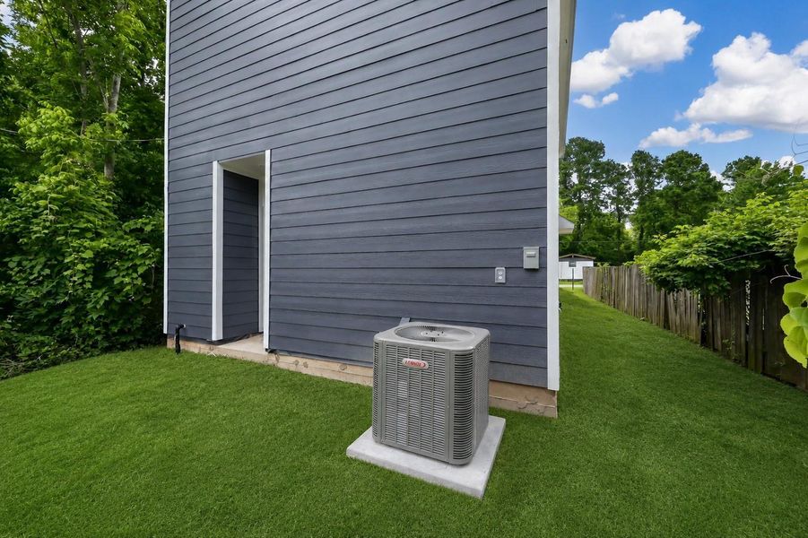 Discover a charming backyard featuring a lush tree line on the left, with grass enhanced for a vibrant, welcoming feel.