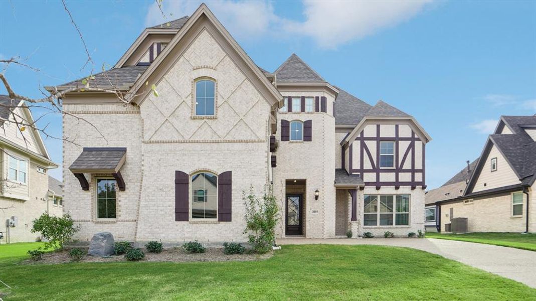 View of front of home with brick siding, a front yard, and a shingled roof View of front of home with brick siding, a front yard, and a shingled roof