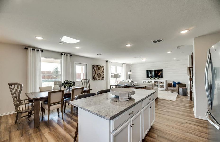 *Model Representation - Large island overlooking gathering room and dining areas