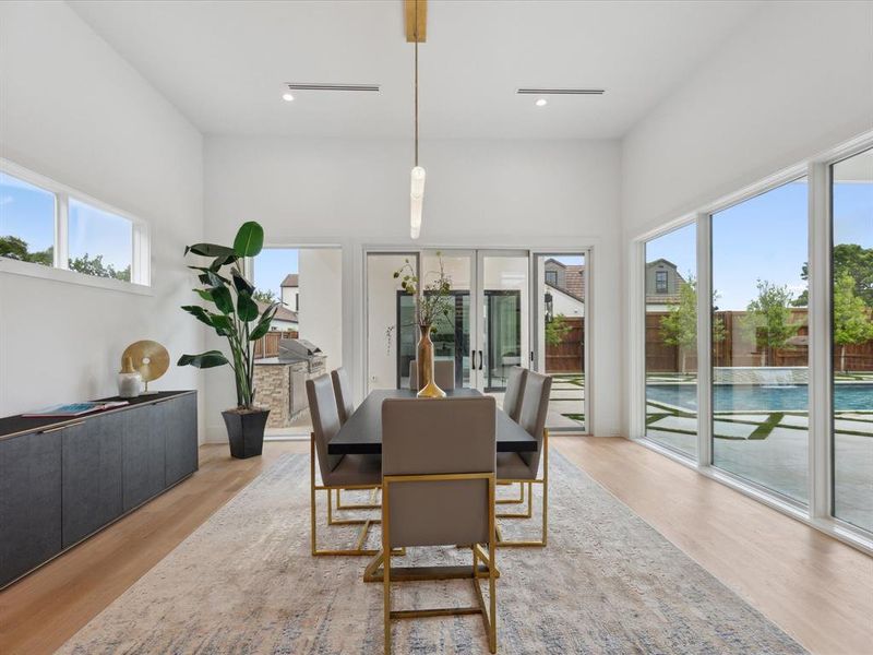 Dining area with hardwood / wood-style flooring, plenty of natural light, and french doors