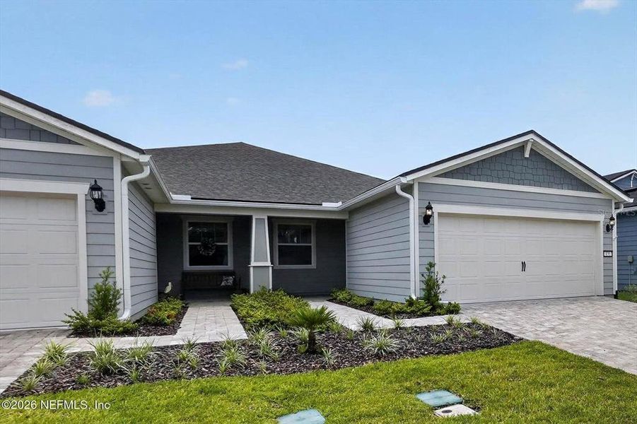 Front exterior of a new home in Del Webb Wildlight, Wildlight, FL, highlighting curb appeal (Image 22).
