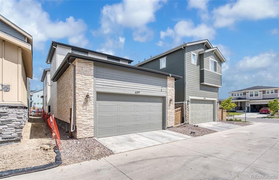 Front exterior of a new home in Painted Prairie, Aurora, CO, highlighting curb appeal (Image 17).