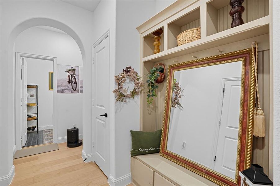Entryway featuring light wood-finish flooring and an arched doorway