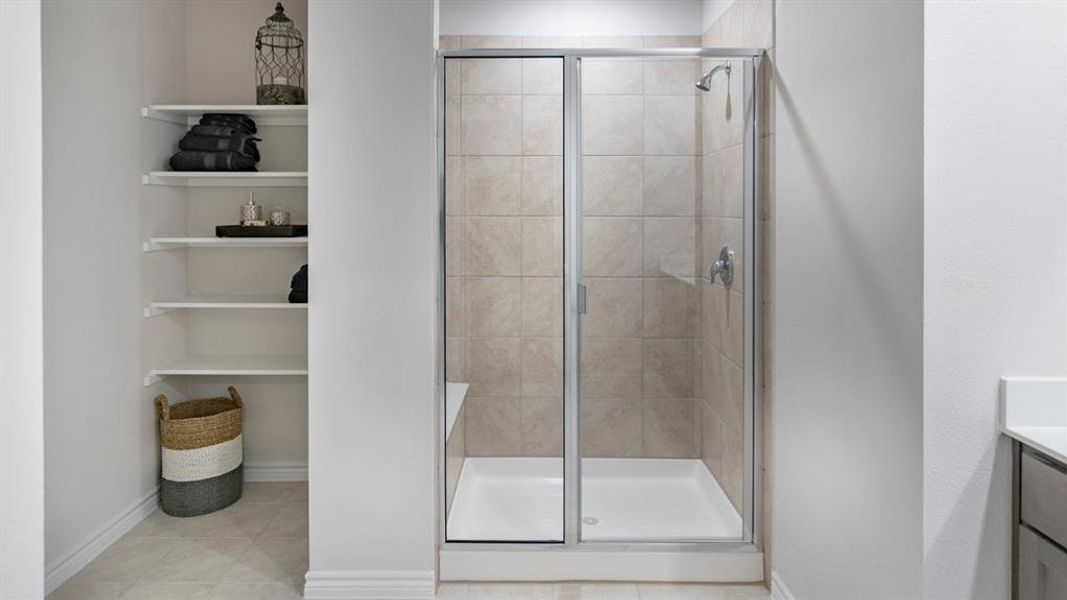 Full bath with a shower stall, vanity, and light tile patterned floors Full bath with a shower stall, vanity, and light tile patterned floors