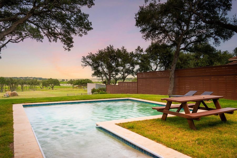 Take in the sunset and Hill Country breeze from your expansive backyard retreat. With scenic views, native landscaping, and multiple gathering areas, this outdoor space is designed for peaceful moments and unforgettable evenings near Canyon Lake.