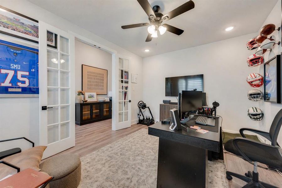 Spacious room featuring French doors, recessed lighting, a ceiling fan, and wood-finish flooring