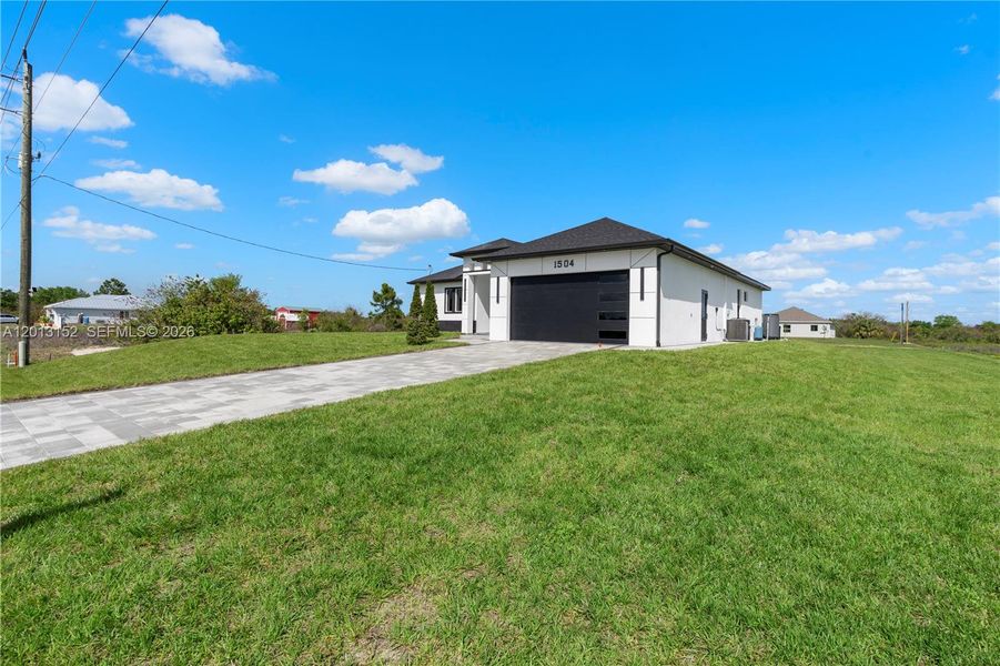 Front exterior of a new home in , Lehigh Acres, FL, highlighting curb appeal (Image 30).