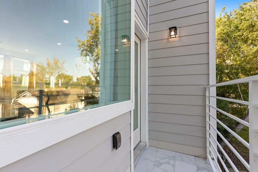 Contemporary balcony with sleek railing and scenic outlook.