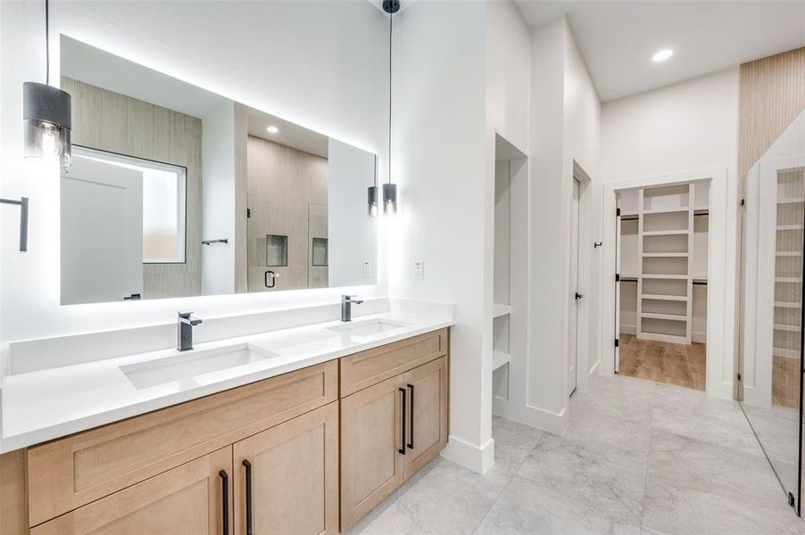 Bathroom with a walk in closet, double vanity, recessed lighting, a stall shower, and a towering ceiling