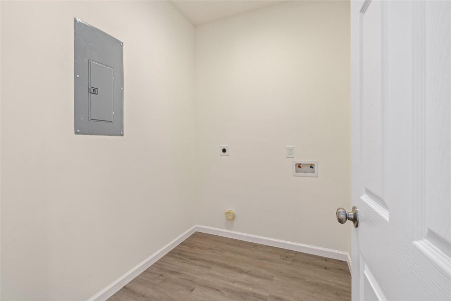 Dedicated utility room with washer/dryer connections and extra storage.