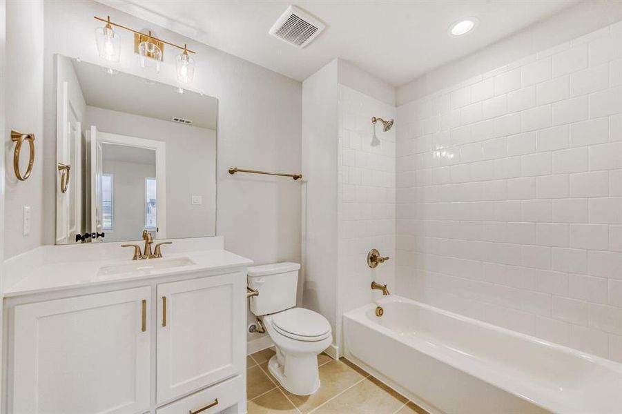 Bathroom with vanity, shower / washtub combination, light tile patterned floors, and recessed lighting