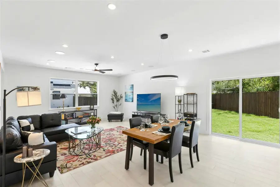 Living room with light wood-style flooring, recessed lighting, and a ceiling fan