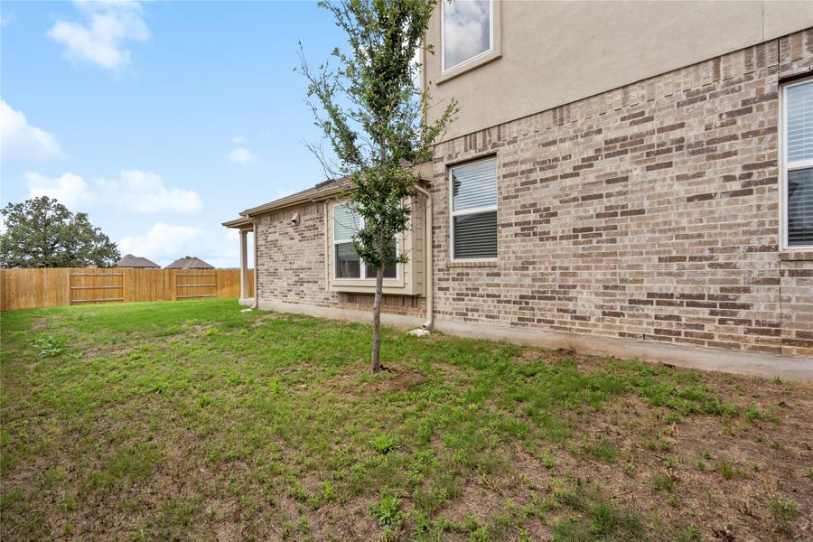 View of side of property featuring brick siding and stucco siding View of side of property featuring brick siding and stucco siding