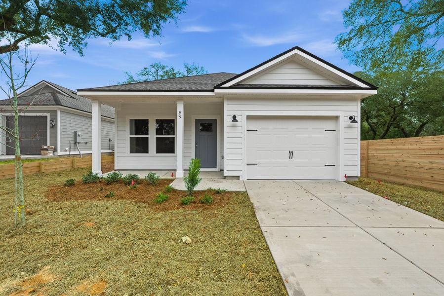 Front exterior of a new home in Live Oak Cottages, Freeport, FL, highlighting curb appeal (Image 1). Front exterior of a new home in Live Oak Cottages, Freeport, FL, highlighting curb appeal (Image 1).
