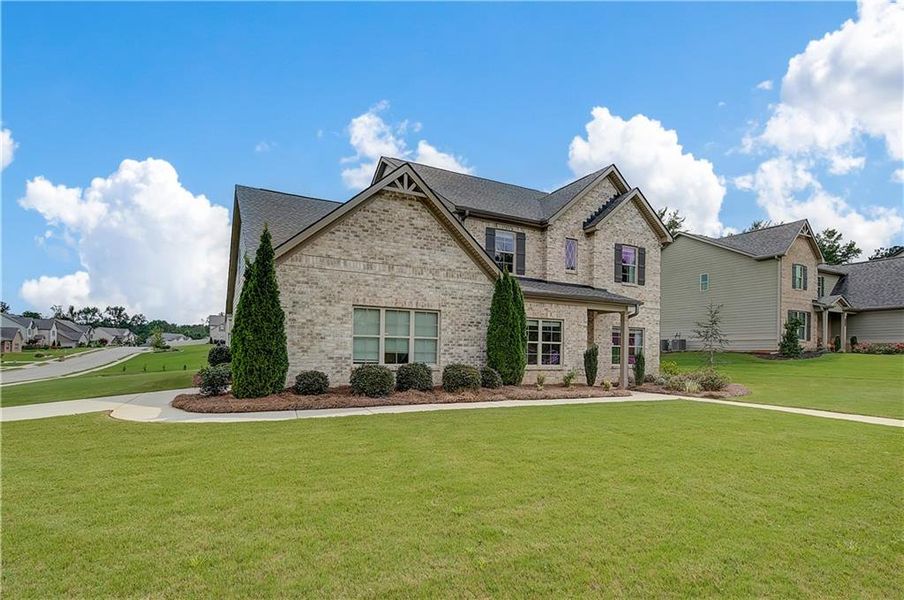 Front exterior of a new home in Traditions at Crystal Lake, Hampton, GA, highlighting curb appeal (Image 18). Front exterior of a new home in Traditions at Crystal Lake, Hampton, GA, highlighting curb appeal (Image 18).